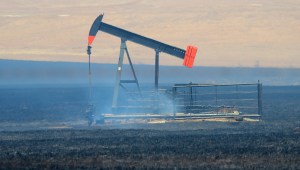 A smoking oil pump jack after a prescribed fire. Photo by Torre Hovick.
